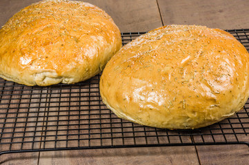 Artisan rosemary bread on cooling rack