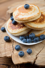 Close-up of homemade fritters with ripe blueberries, studio shot
