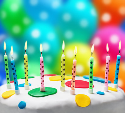 burning candles on a birthday cake