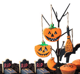 homemade cookies for Halloween hanging on a tree on a white