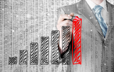 Business man drawing a growing graph