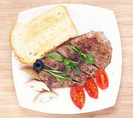 grilled meat on a plate serving rustic wooden background