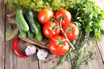 Fresh vegetables with herbs and spices on table, close-up
