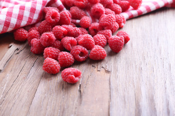 Ripe sweet raspberries on table close-up