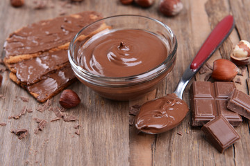 Sweet chocolate cream in bowl on table close-up