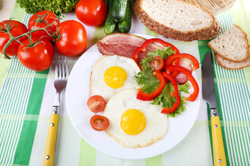 Scrambled eggs with bacon and vegetables served