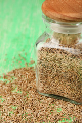 Bay seeds in a glass square bottle with wooden lid