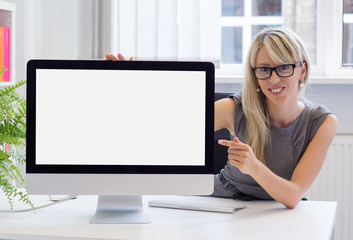Creative young woman showing blank presentation on screen - obrazy, fototapety, plakaty