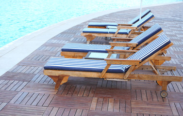 Lounge sunbeds near swimming pool