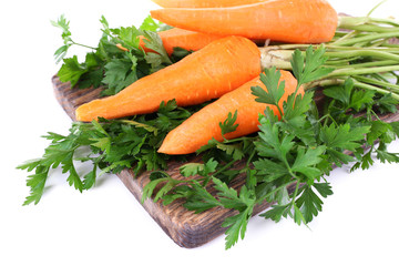 Carrots and parsley on cutting board isolated on white