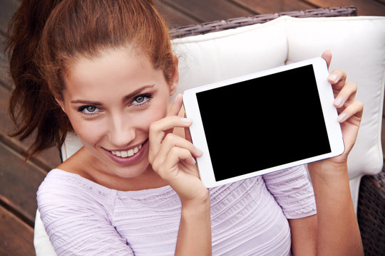 young beautiful woman shows on tablet
