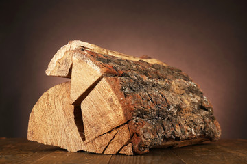 Heap of firewood on floor on dark background