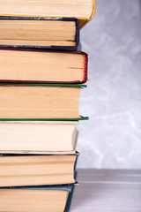 Books on wooden table on light background