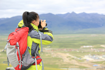 young woman photographer taking photo outdoor