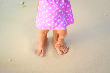 Fototapeta na wymiar father and little daughter feet on a tropical beach