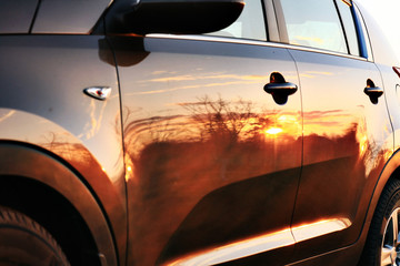 car sunset reflection