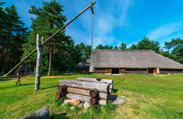 Fototapeta na wymiar Traditional wooden country hut and well