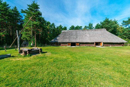 Traditional wooden country hut and well