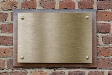Brass or bronze metal plate on brick wall