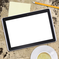 Tablet pc and coffee cup on old concrete surface