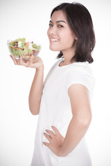 Pretty girl eating fresh vegetable salad