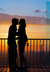 Couple in love at Paris admire Eiffel Tower at sunset