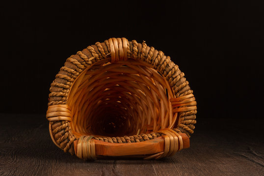 Wicker basket isolated on dark background