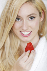 Woman enjoying fresh strawberry