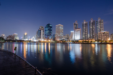 Fototapeta na wymiar Bangkok city at night with reflection of skyline