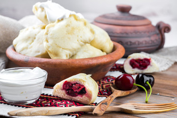 Ukrainian dumplings with cabbage, cheese and cherries