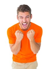 Excited man in orange cheering