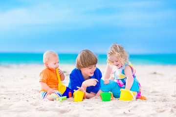 Three kids playing on a beach