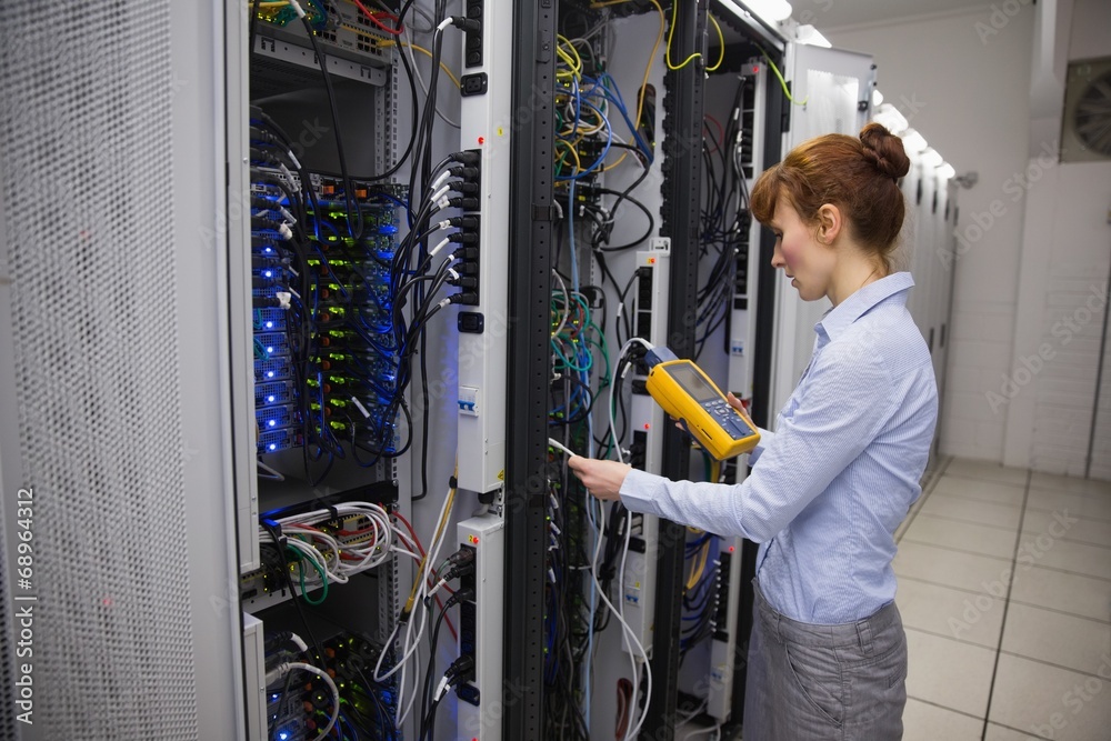 Aufkleber technician using digital cable analyzer on server