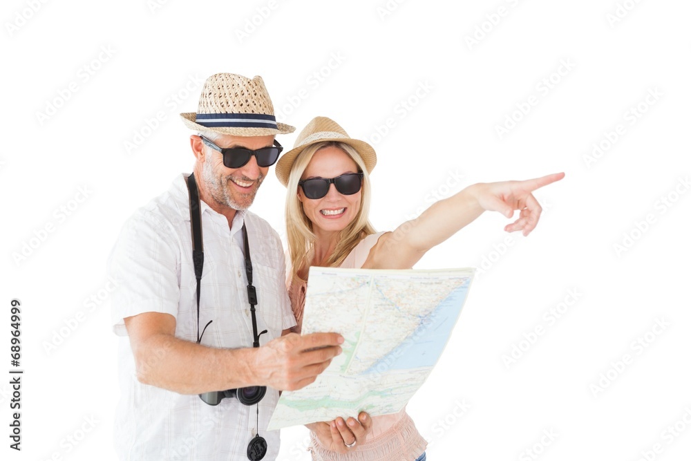 Poster happy tourist couple using map and pointing