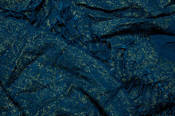 gold and blue fabric with fringe background