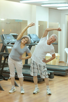 senior couple exercising in gym