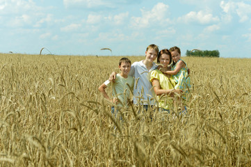 Family standing in field