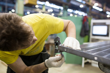 Man Worker Measuring detail with Protractor in Workshop
