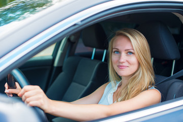 Fototapeta na wymiar Beautiful young woman driving a car.