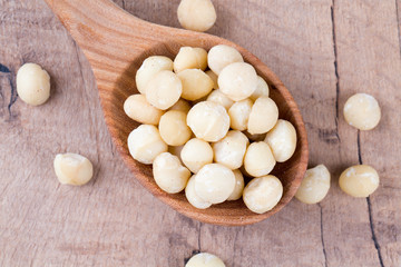 macadamian nuts in a wooden spoon