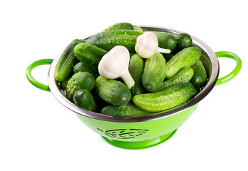 fresh cucumbers in a green colander