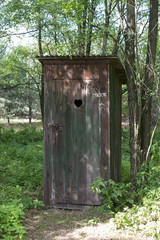 Fototapeta na wymiar Old wooden outdoors toilet in summer.