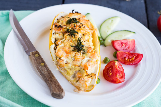 stuffed zucchini with chicken and vegetables, horizontally, knif