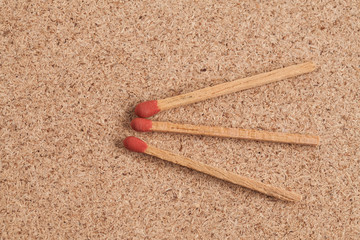 red matches on a wood background.