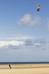 Man playing with a kite at the beach