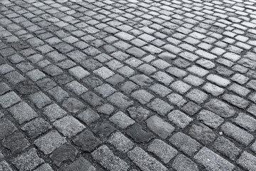Old wet stone paved avenue street road
