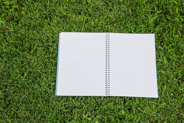 Notebook on grass background