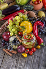 canned pepper and pear with autumn fruits and vegetables around