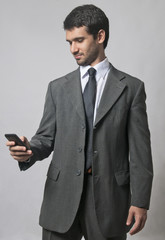 Young businessman looking at smartphone