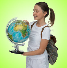 Smiling young schoolgirl with a globe